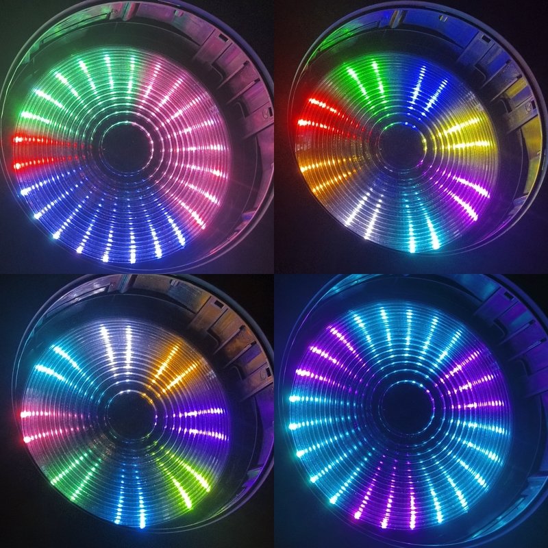 Four circular LED displays, each showcasing vibrant, symmetrical patterns in various arrangements of red, green, blue, purple, and yellow—arranged in sectors reminiscent of spinning wheels. Inspired by the dynamic lighting effects of the IP20 150W Moving Mac One series, these displays evoke a sense of motion and energy.